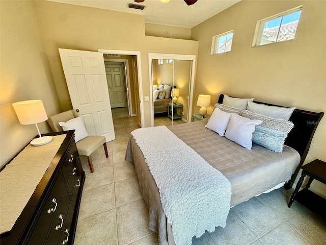 bedroom featuring a closet, light tile patterned flooring, and ceiling fan