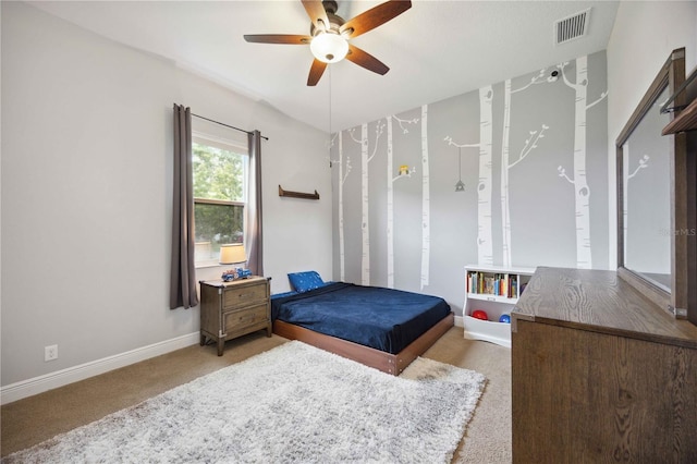 bedroom featuring light colored carpet, baseboards, and ceiling fan