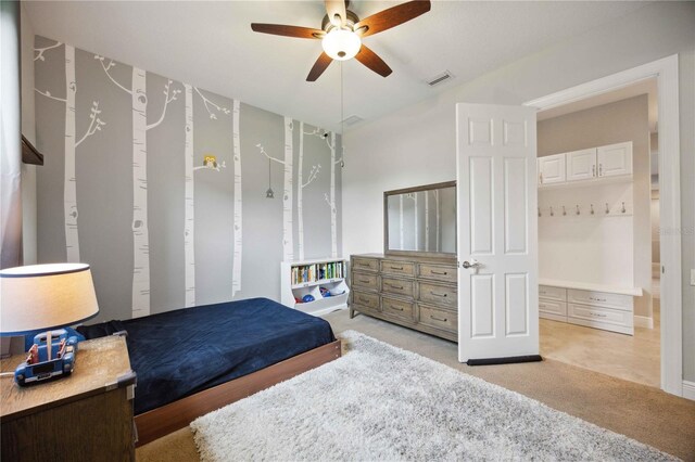 bedroom featuring light carpet, lofted ceiling, and ceiling fan