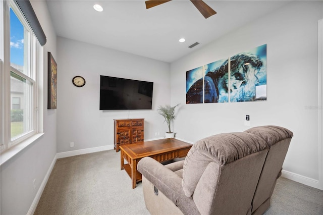 carpeted living area with baseboards, recessed lighting, and a ceiling fan