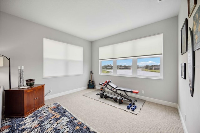 exercise room featuring carpet flooring and baseboards