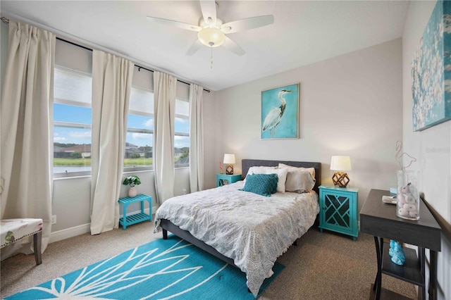 carpeted bedroom with baseboards and ceiling fan