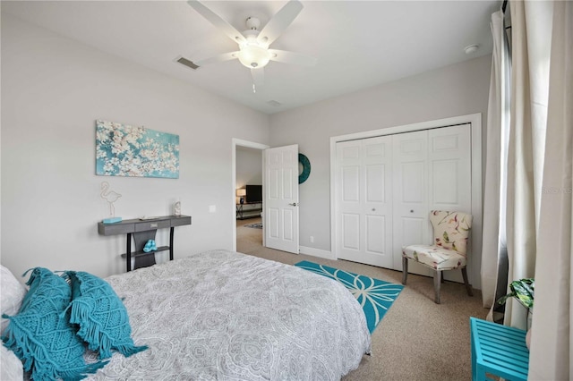 carpeted bedroom featuring a closet and ceiling fan