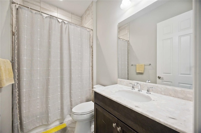 bathroom featuring toilet, vanity, and a shower with curtain