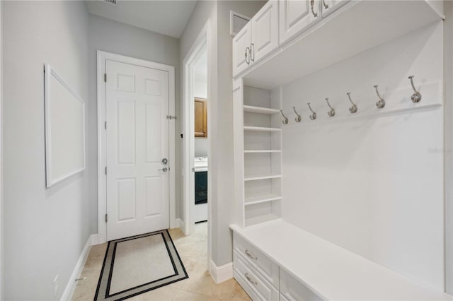 mudroom with baseboards and light tile patterned floors