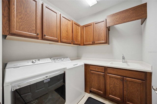 clothes washing area featuring washing machine and clothes dryer and cabinet space