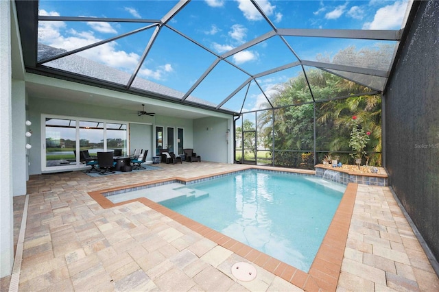 outdoor pool with a patio, a ceiling fan, outdoor dining area, and glass enclosure