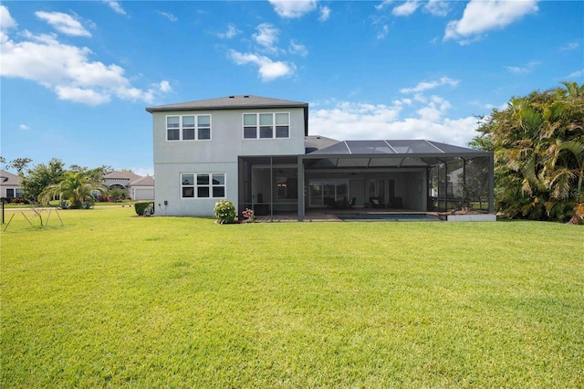 rear view of property featuring a lawn, stucco siding, and glass enclosure