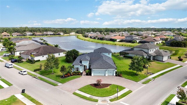 aerial view of residential area featuring a nearby body of water