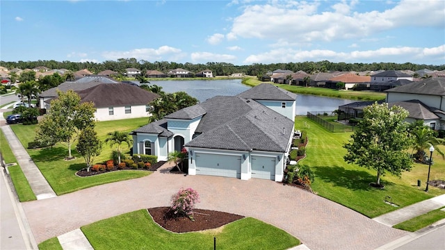 aerial view of residential area featuring a large body of water