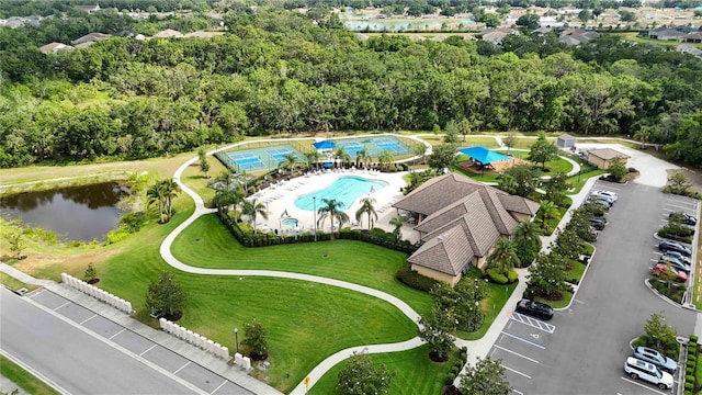 aerial view of a pool and a nearby body of water