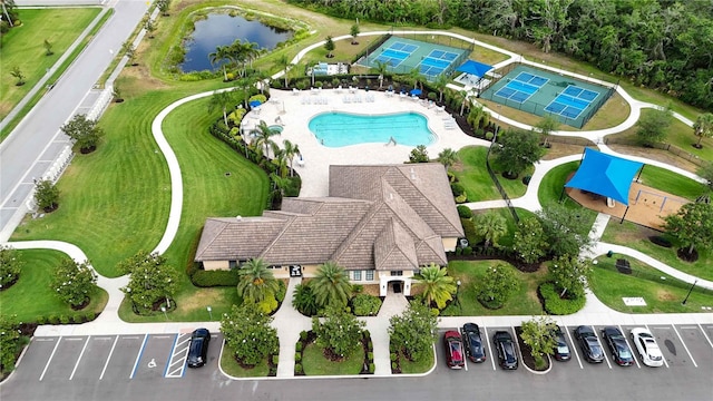 drone / aerial view of a pool and a large body of water