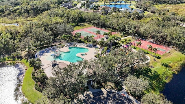drone / aerial view of a pool and a large body of water