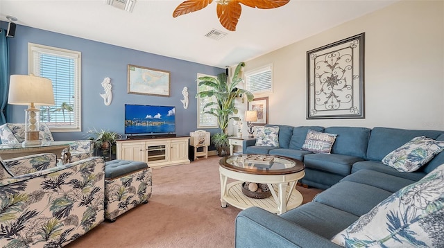 living area with light colored carpet and ceiling fan