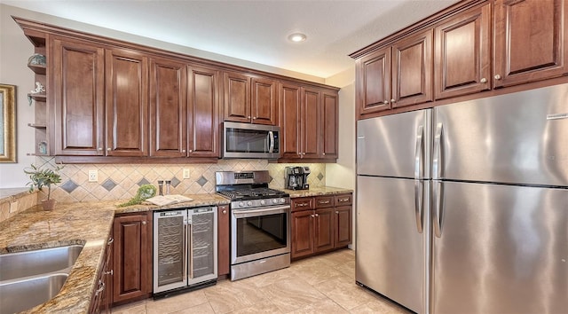 kitchen with appliances with stainless steel finishes, wine cooler, open shelves, decorative backsplash, and light stone counters