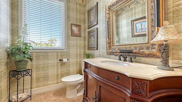 bathroom featuring toilet, wallpapered walls, vanity, and tile patterned flooring