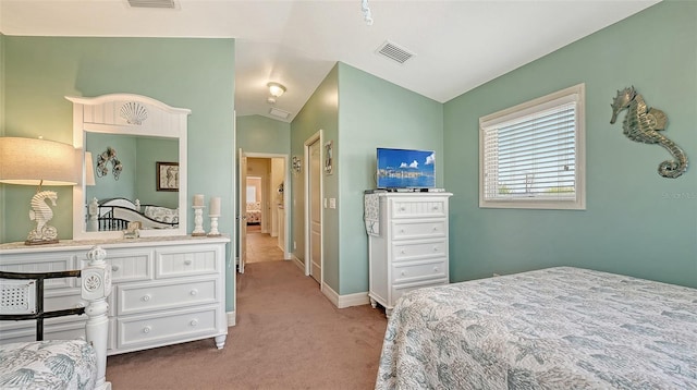 carpeted bedroom with lofted ceiling and baseboards