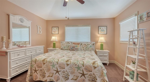 bedroom featuring dark colored carpet, baseboards, and a ceiling fan