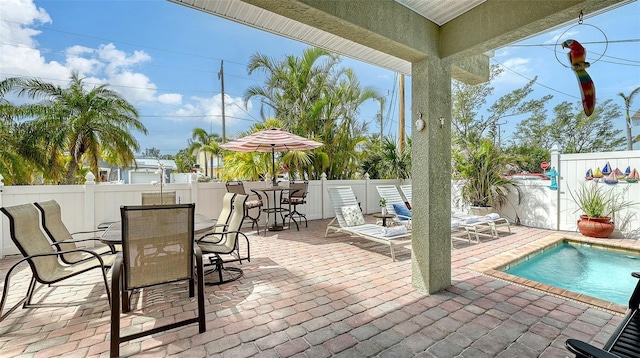 view of patio with a fenced backyard and outdoor dining space