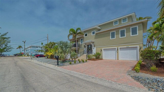 view of front facade featuring a garage and decorative driveway