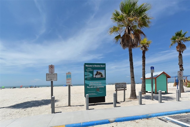 view of community featuring view of water and beach