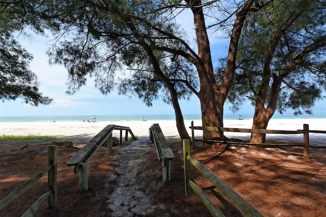 view of home's community featuring view of water and beach