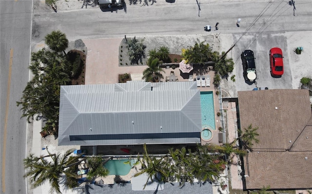 aerial view of property and surrounding area featuring a pool