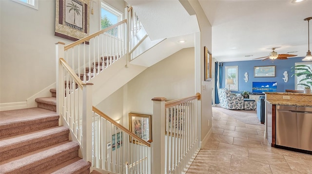 stairway featuring a ceiling fan, recessed lighting, and baseboards
