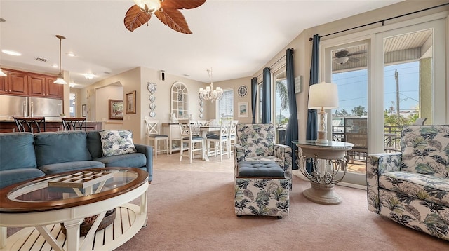carpeted living room featuring ceiling fan, a chandelier, and recessed lighting