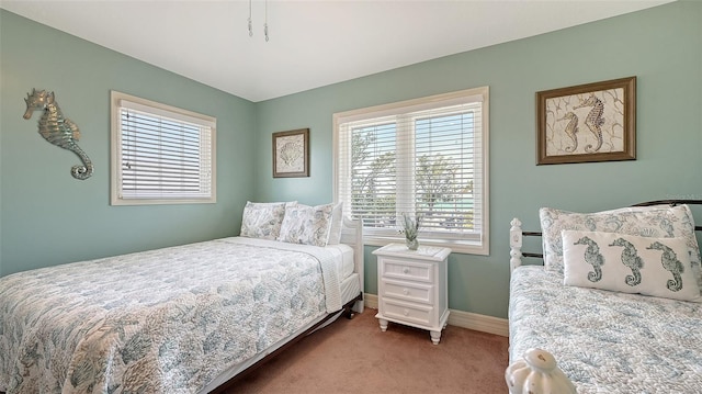 carpeted bedroom featuring baseboards