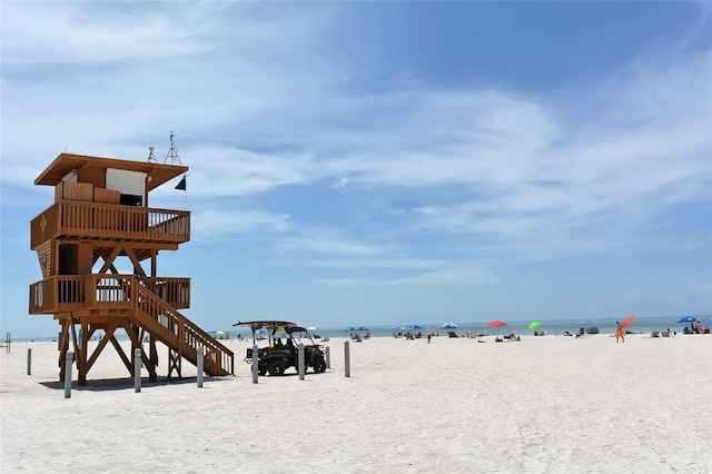 view of property's community with view of water and beach