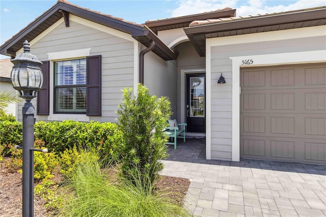 5165 Coral Reef Way, Bradenton, FL 34211 - view of exterior entry featuring an attached garage