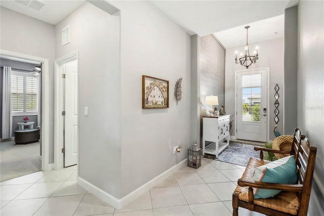 5165 Coral Reef Way, Bradenton, FL 34211 - entryway with healthy amount of natural light, a chandelier, light tile patterned floors, and baseboards