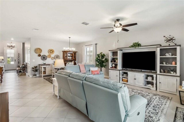 5165 Coral Reef Way, Bradenton, FL 34211 - living area with a chandelier, a ceiling fan, plenty of natural light, and light tile patterned floors
