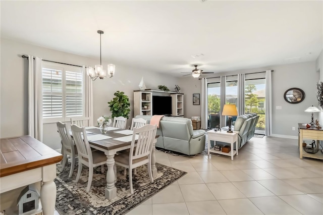 5165 Coral Reef Way, Bradenton, FL 34211 - dining space featuring ceiling fan, a chandelier, and light tile patterned floors