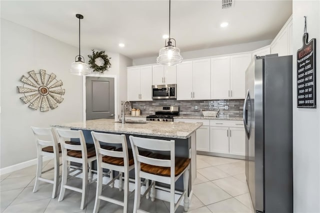 5165 Coral Reef Way, Bradenton, FL 34211 - kitchen with appliances with stainless steel finishes, white cabinetry, tasteful backsplash, a sink, and recessed lighting