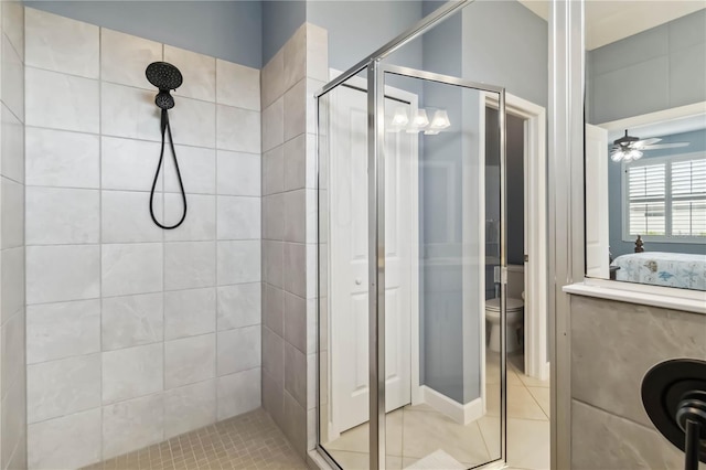 5165 Coral Reef Way, Bradenton, FL 34211 - ensuite bathroom with a shower stall, toilet, tile patterned flooring, and a ceiling fan