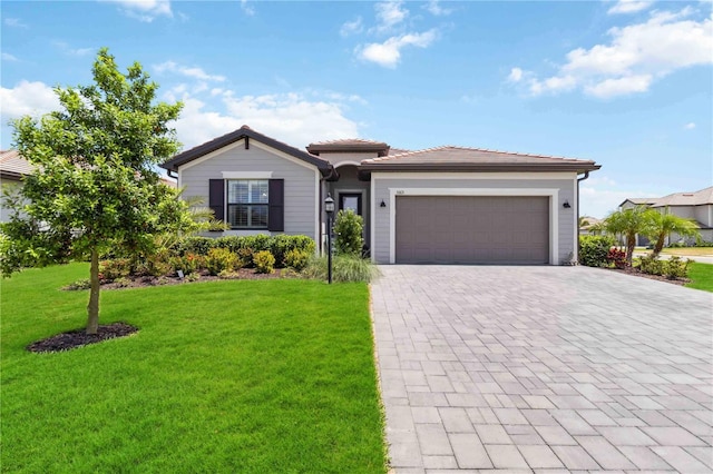 5165 Coral Reef Way, Bradenton, FL 34211 - view of front of house with decorative driveway, a front lawn, a garage, and a tiled roof