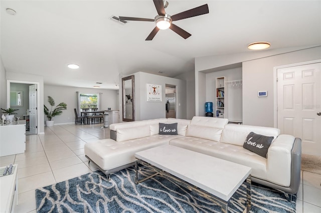 living area with tile patterned floors, a ceiling fan, lofted ceiling, and recessed lighting