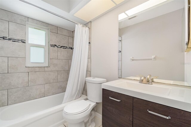 bathroom with toilet, shower / bathtub combination with curtain, and vanity