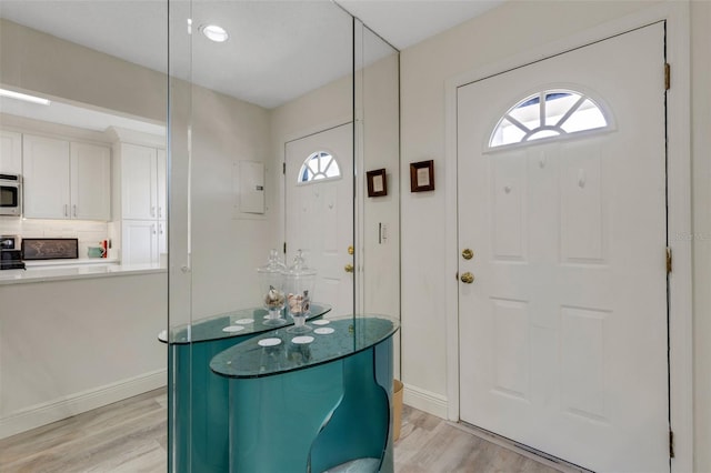 5632 Ashton Lake Dr Unit 5632, Sarasota, FL 34231 - foyer entrance featuring light wood finished floors, plenty of natural light, and baseboards