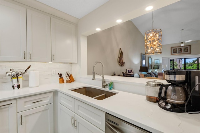5632 Ashton Lake Dr Unit 5632, Sarasota, FL 34231 - kitchen with a sink, tasteful backsplash, white cabinets, open floor plan, and vaulted ceiling