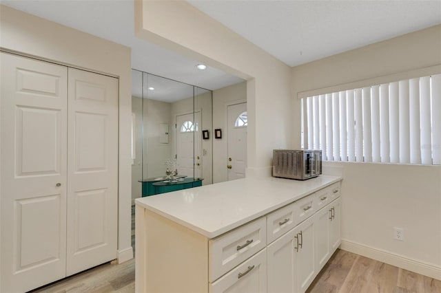 5632 Ashton Lake Dr Unit 5632, Sarasota, FL 34231 - kitchen featuring light wood-type flooring, white cabinetry, baseboards, light countertops, and recessed lighting