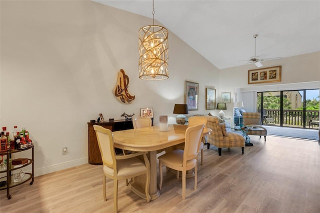 5632 Ashton Lake Dr Unit 5632, Sarasota, FL 34231 - dining room with high vaulted ceiling, light wood-style flooring, baseboards, a ceiling fan, and a chandelier
