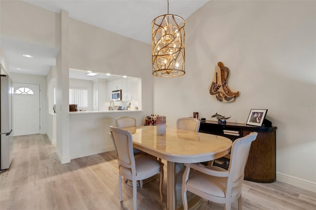 5632 Ashton Lake Dr Unit 5632, Sarasota, FL 34231 - dining space featuring light wood-style floors, a chandelier, and baseboards