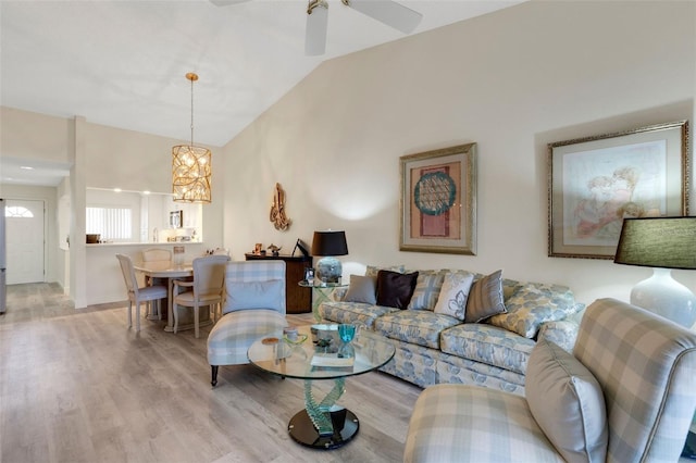5632 Ashton Lake Dr Unit 5632, Sarasota, FL 34231 - living area with light wood finished floors, vaulted ceiling, a chandelier, and a ceiling fan