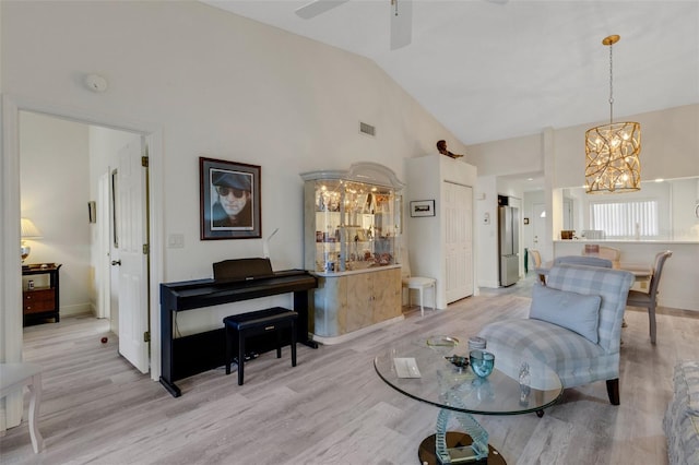 5632 Ashton Lake Dr Unit 5632, Sarasota, FL 34231 - living area with a chandelier, light wood-style floors, high vaulted ceiling, ceiling fan, and baseboards
