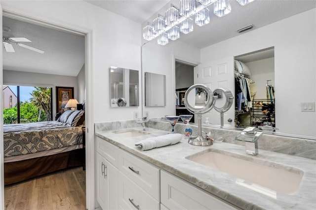 5632 Ashton Lake Dr Unit 5632, Sarasota, FL 34231 - full bath with ensuite bathroom, a textured ceiling, wood finished floors, ceiling fan, and double vanity