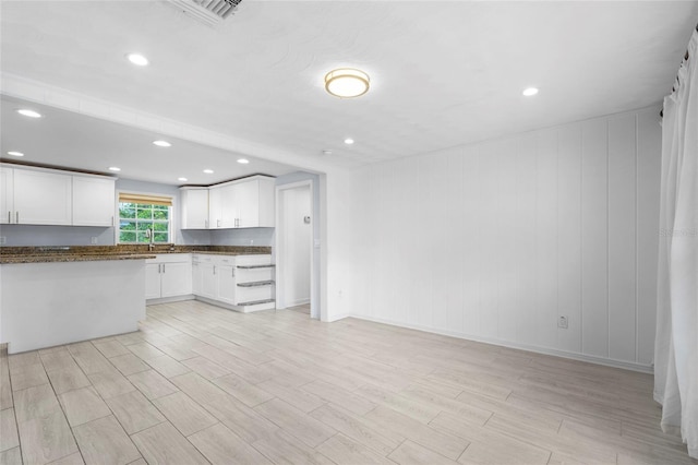 3616 Stardust Pl, Sarasota, FL 34232 - kitchen with a sink, light wood-style flooring, white cabinetry, recessed lighting, and baseboards