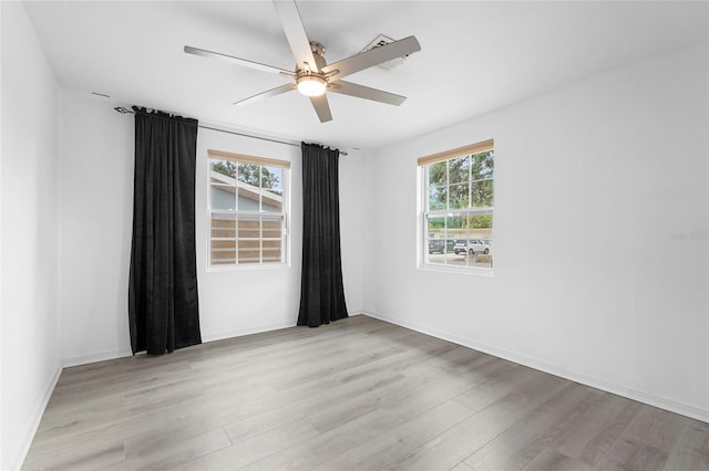 3616 Stardust Pl, Sarasota, FL 34232 - empty room featuring light wood-type flooring, ceiling fan, and baseboards